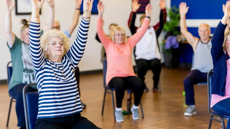 seniors exercising sitting in chairs